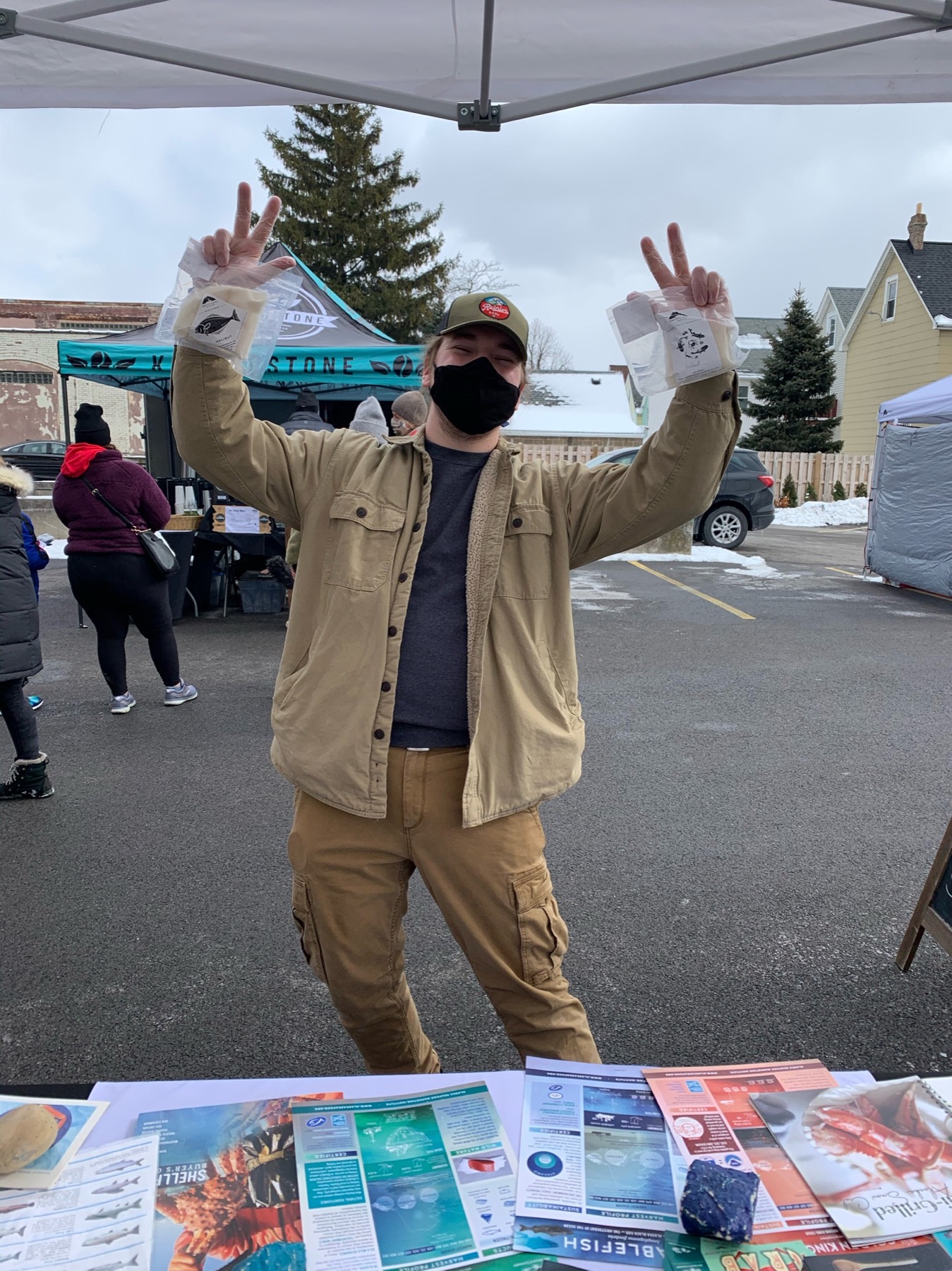 Farmers market customer holding Pacific Cloud seafood boxes