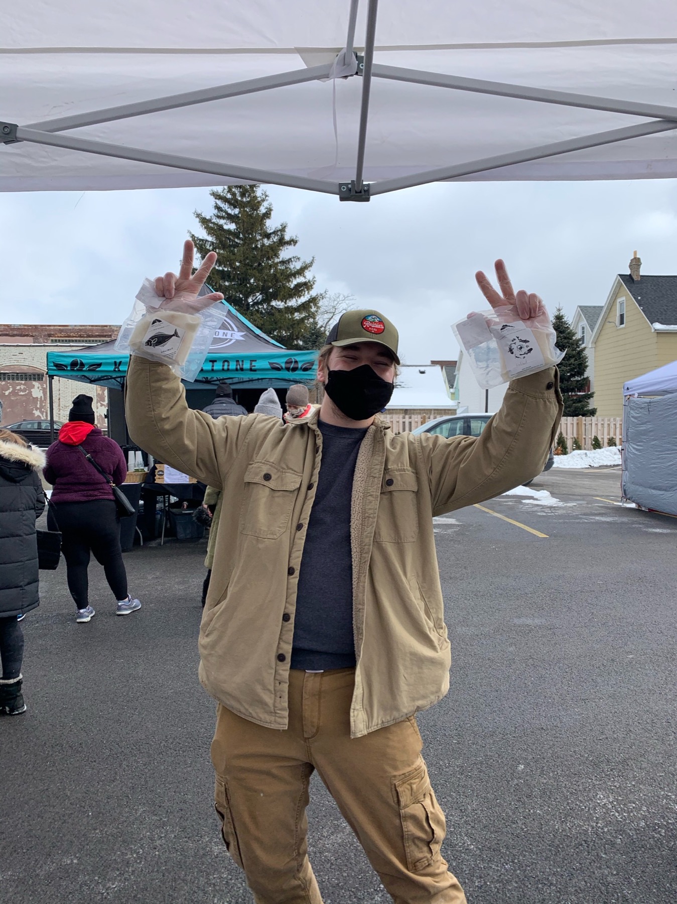 Farmers market customer holding two bags of Pacific Cloud seafood