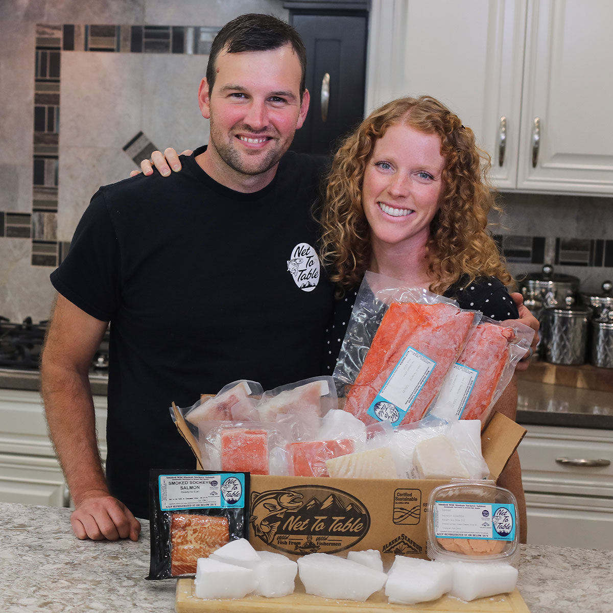 Net To Table Seafoods founders Luke and Eliza Owens with a wild-caught seafood box