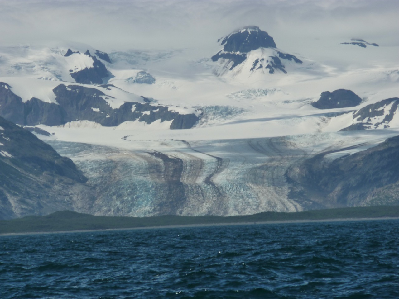 Snow-capped Kodiak mountains rising above the water